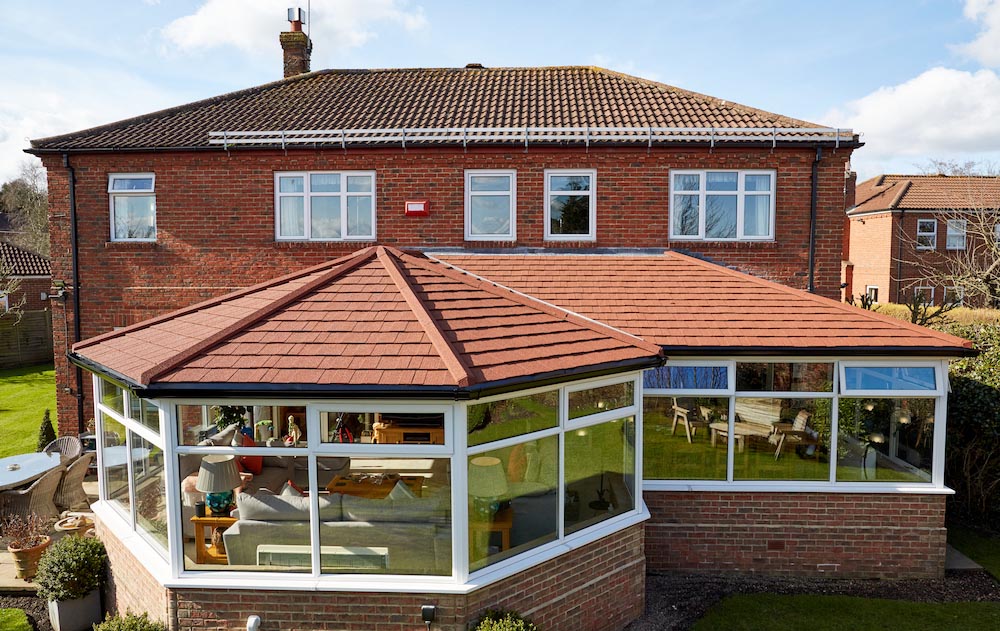 large p-shaped tiled roof conservatory